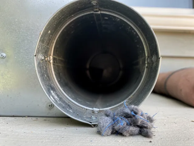 Deltona Dryer Vent Cleaning technician using specialized equipment to clear severe dryer vent blockage in Deltona